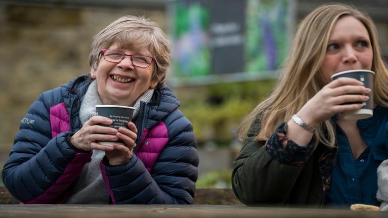 Visitor enjoying a warm drink on a cold day from the Clocktower cafe